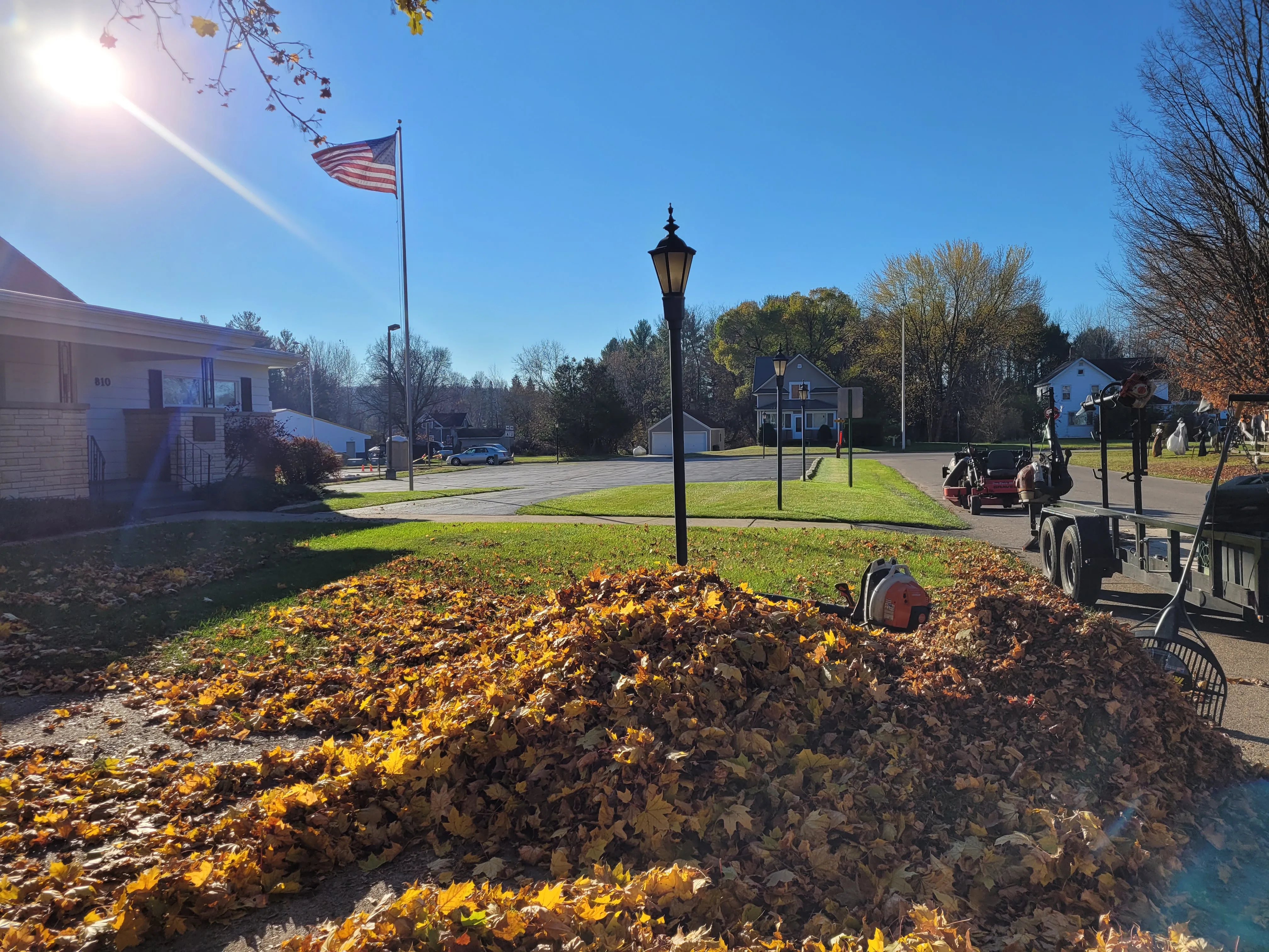 Spring lawn cleanup service Shawano WI - massive pile of leaves and debris removal