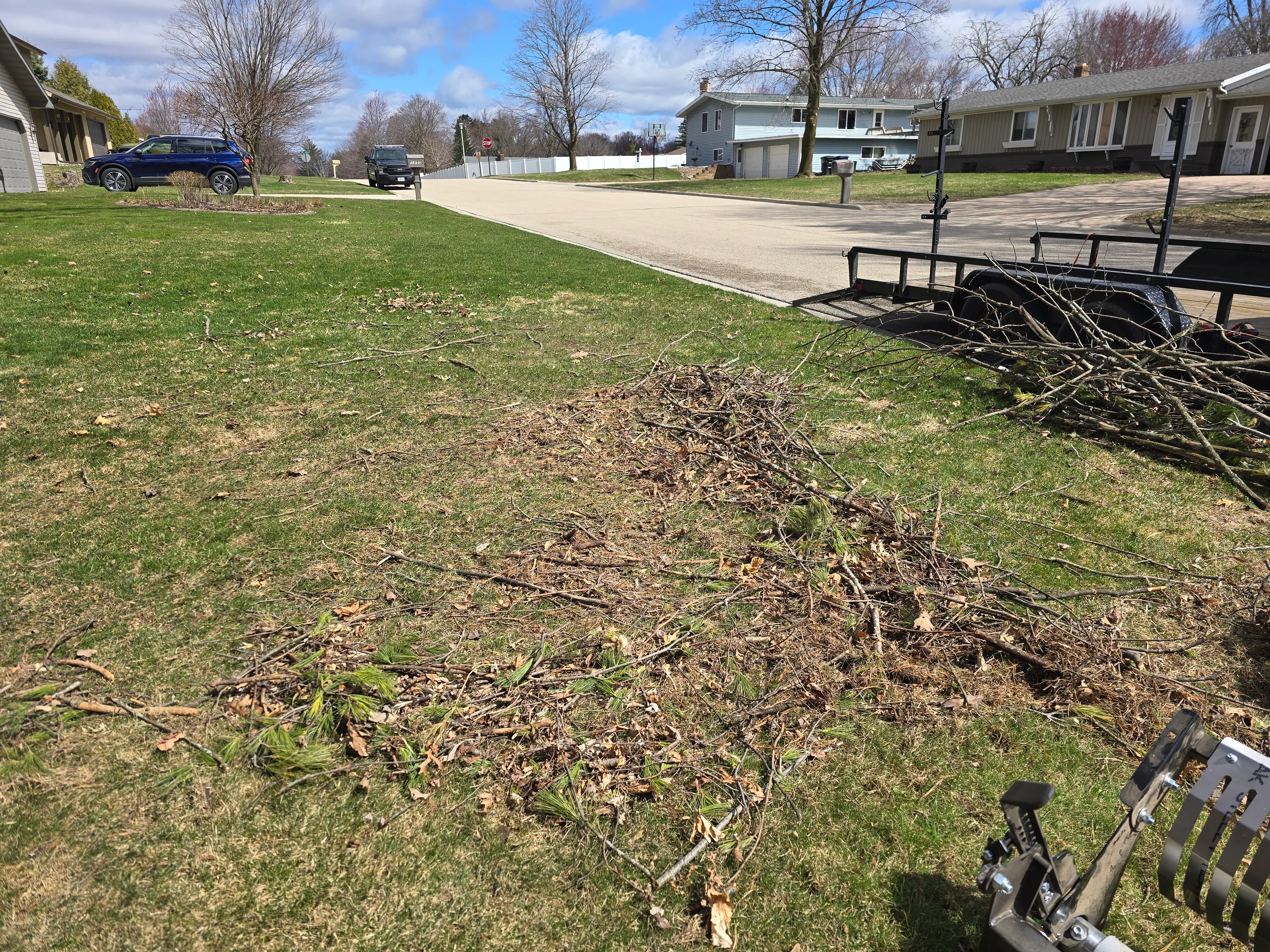 Spring lawn cleanup service Shawano WI - winter debris and stick removal from residential yard